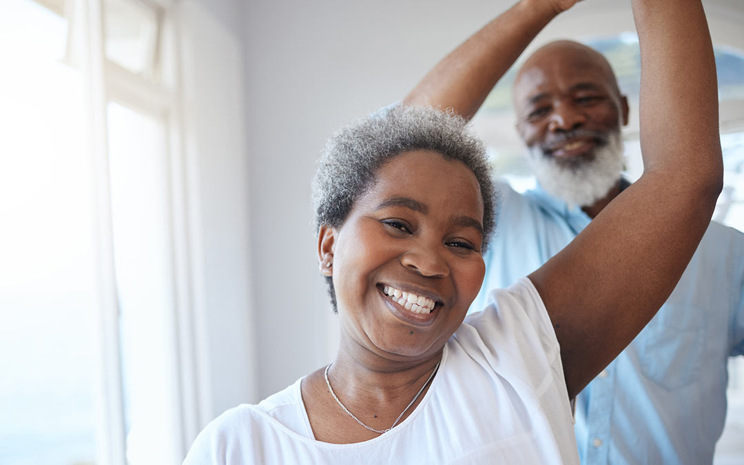 mature couple dancing together inside