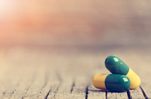 Pharmacy background. Pills on a wooden table. Medicine. Natural background