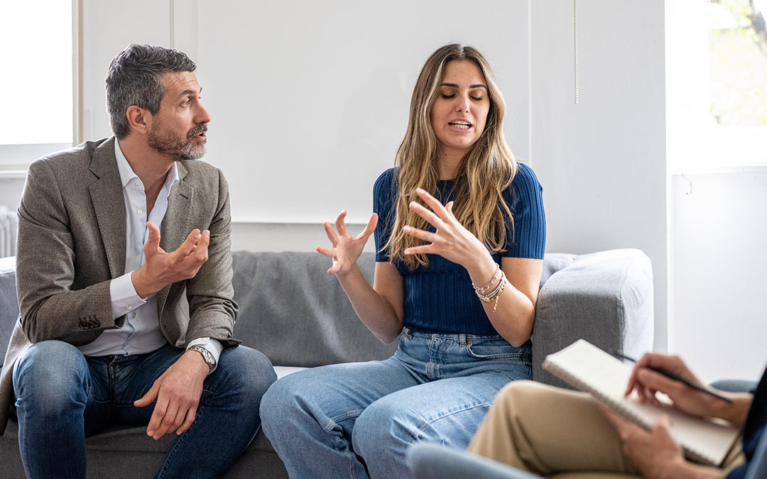 a man and a woman disagreeing in a mediation session