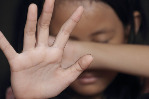 girl with hands in front of face