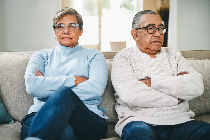 older couple with their arms crossed